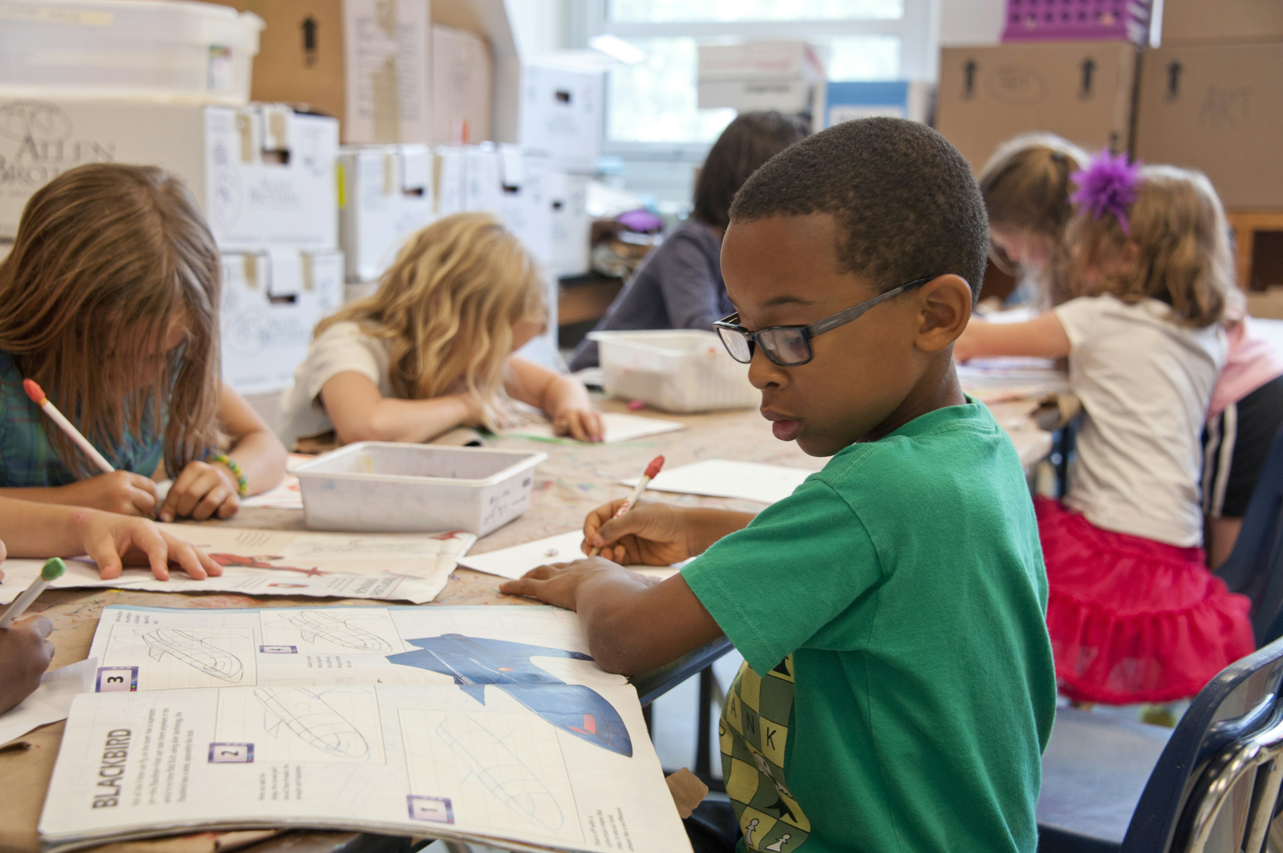 Small children sitting at a school table