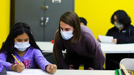Amanda Becker helps a student. Amanda is the director of the After School Center at New City Kids, Detroit.