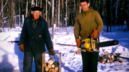 Roger (left) and Ron Bouwkamp (right) cut firewood for the Sunday service.