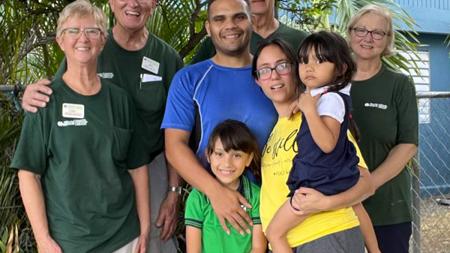 Jose and his family stand with World Renew disaster response volunteers.