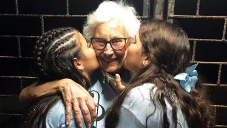 Win Gritter hugs a few young girls in Cuba who call her “Grandma.”