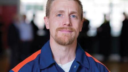 Photo Caption 	Chris Bernaiche will graduate with a bachelor’s degree on May 10, 2024, inside Handlon Correctional Facility.