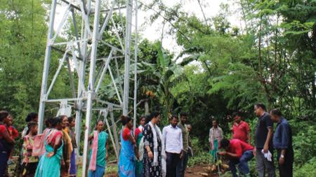 A newly installed water tank provides access to safe drinking water for a village in India.