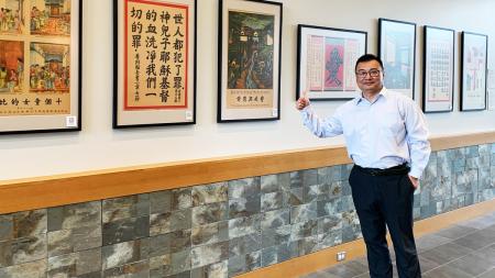 ReFrame’s Chinese ministry leader, Jerry An, with some of the posters currently on display at Wheaton (Ill.) College.