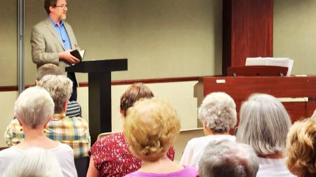Zach King speaks to guests during a celebration service to mark the closing of the CRCNA offices on the corner of 28th street and Kalamazoo Ave. in Grand Rapids, Michigan. 