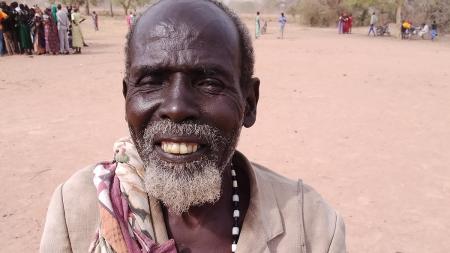Malual Apath holding the money he received at the April cash distribution.