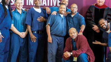 Todd Cioffi standing with students in the Calvin Prison Initiative program during a recent commencement ceremony inside Handlon Correctional Facility.