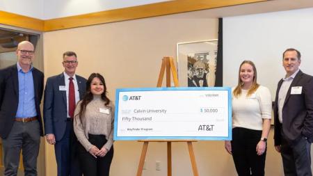Calvin University president Greg Elzinga (second from left) accepts a check from AT&T to be used for laptops, educational software, and essential digital literacy support for students in need. 