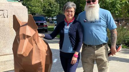 Resonate missionary Pamela Alderman stands with Laszlo Szalay beside his sculpture Emperor. 