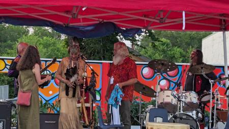 Bert Adema (in red shirt) introduces performers at a celebratory concert in Regina, Sask.