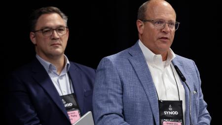 Noah Toly (Calvin Provost) and Perrin Rynders (incoming Calvin board chair) address Synod 2025