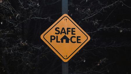 A yellow road side that reads "safe place"