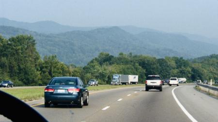 The view is from inside a car that is driving down a highway