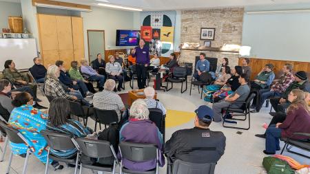 Adrian Jacobs (in purple) speaks to participants at a time of on-the-land learning.