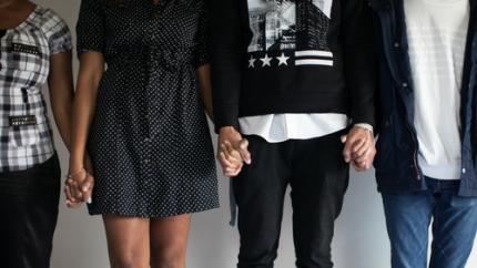 young people hold hands