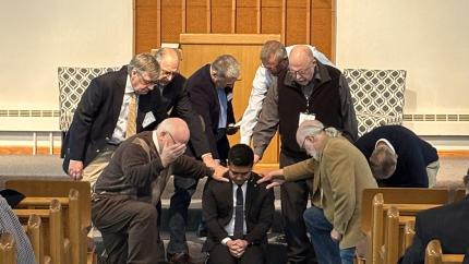Members of Ideal Park CRC lay hands on Rev. Jake Jeong during his ordination.