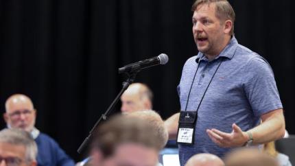 Jeff Bennett speaks into a microphone