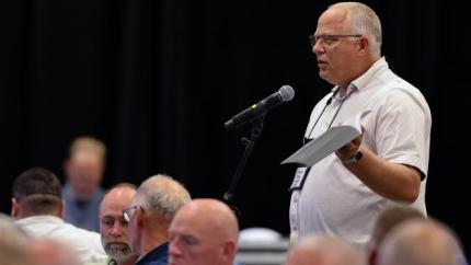 Gary vanLeeuwen speaks into a microphone