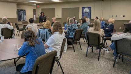 Women gathered for dinner around tables