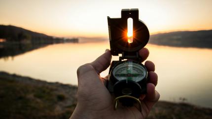 a navigational compass pointed at the sun