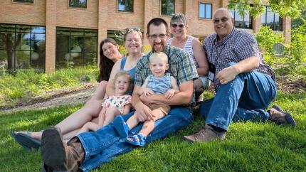 A family sitting on a lawn