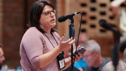 Synod 2026 delegate speaks into a microphone
