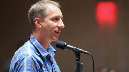 Synod 2026 delegate speaks into a microphone