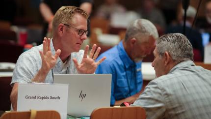 Synod 2026 delegates at a table