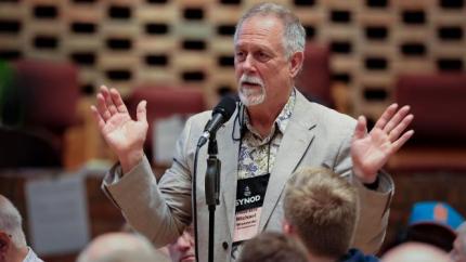 Synod 2026 Parliamentarian speaking into a microphone