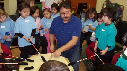 Harold Roscher helps lead a drumming circle.