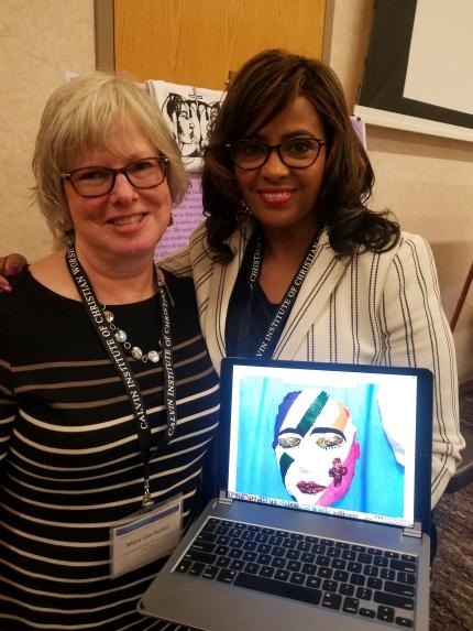 Mary Lee Hultin and Regina Crudup show a laptop image of a mask made as part of their worship project.