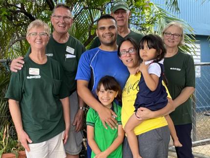Jose and his family stand with World Renew disaster response volunteers.