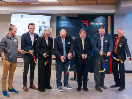 President David Zietsma, board chair Denis St. Amour, board vice chair Gina Taylor-Lunshof, academic vice president Peter Neumann, Innovation Centre director Harold DeVries, and student senate president Sebastian Caldwell participated in an official ribbon-cutting ceremony.