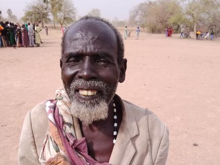 Malual Apath holding the money he received at the April cash distribution.