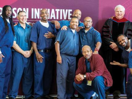 Todd Cioffi standing with students in the Calvin Prison Initiative program during a recent commencement ceremony inside Handlon Correctional Facility.