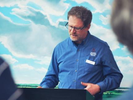 General Secretary, Zach King, speaks to those who attended the May 22 open house. 