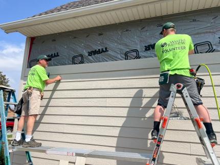 Volunteers repair a flood-damaged home in Iowa.