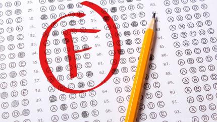 A test paper has a large F circles on it in red ink, indicating a failed test.