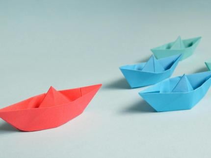 Blue and red paper boats