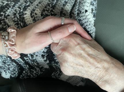 A young hand holding an old hand
