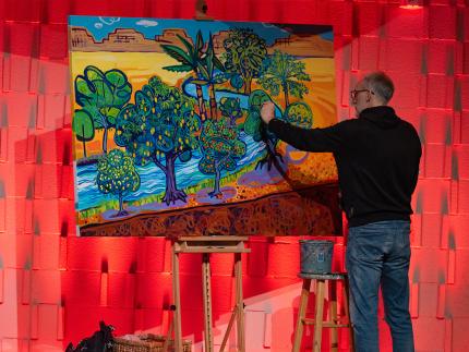 Joel Schoon-Tanis painted a desert scene representing the Psalms during the event.