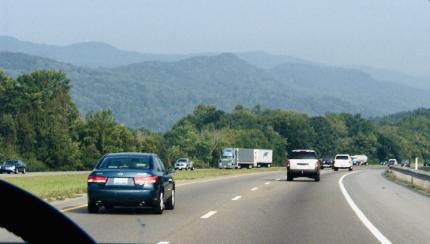 The view is from inside a car that is driving down a highway