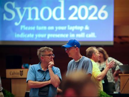 Two delegates conversing on the last day of synod. 