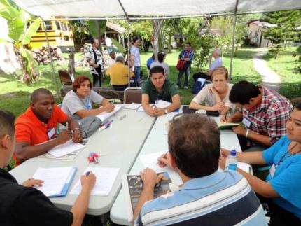 A small group discusses IMPACT.