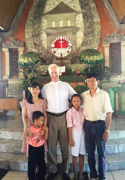 Robert Koornneef with a family inside the church he pastored.