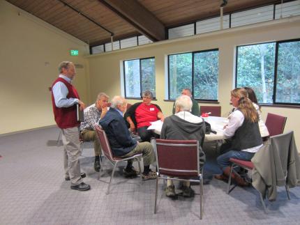 Rev. Gary Bekker and Rev. Darren Roorda speak about the SPACT report with a table of CRC members.
