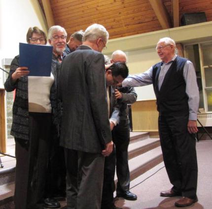 Pastors lay hands on Shiao Chong, commissioning him as the new editor of The Banner.