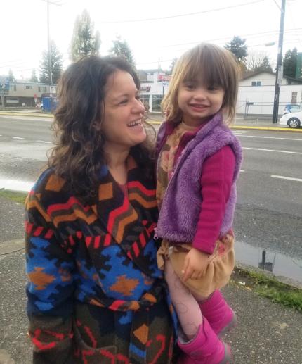 Christy Bauman, holds her daughter Selah, outside Awake Church.