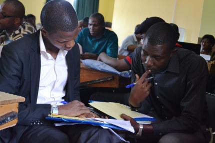 Daniel (right) works with a student