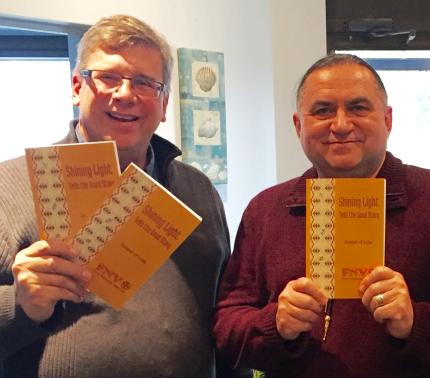 Terry Wildman, right, and Wayne Johnson celebrate the printing of the First Nations Version of the Gospel of Luke.